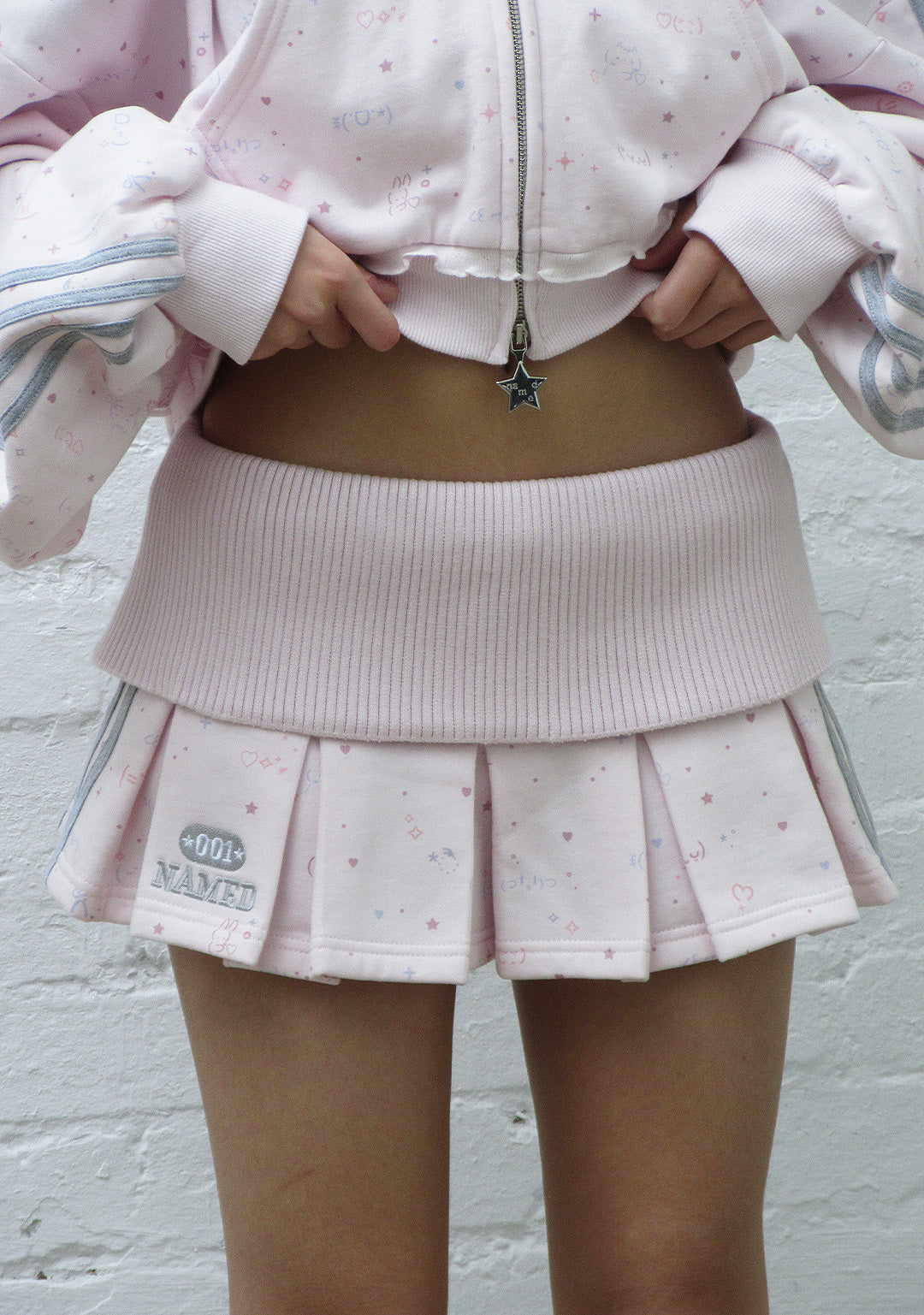 MALFUNCTION SPORTY PLEATED MINI SKIRT BABY PINK