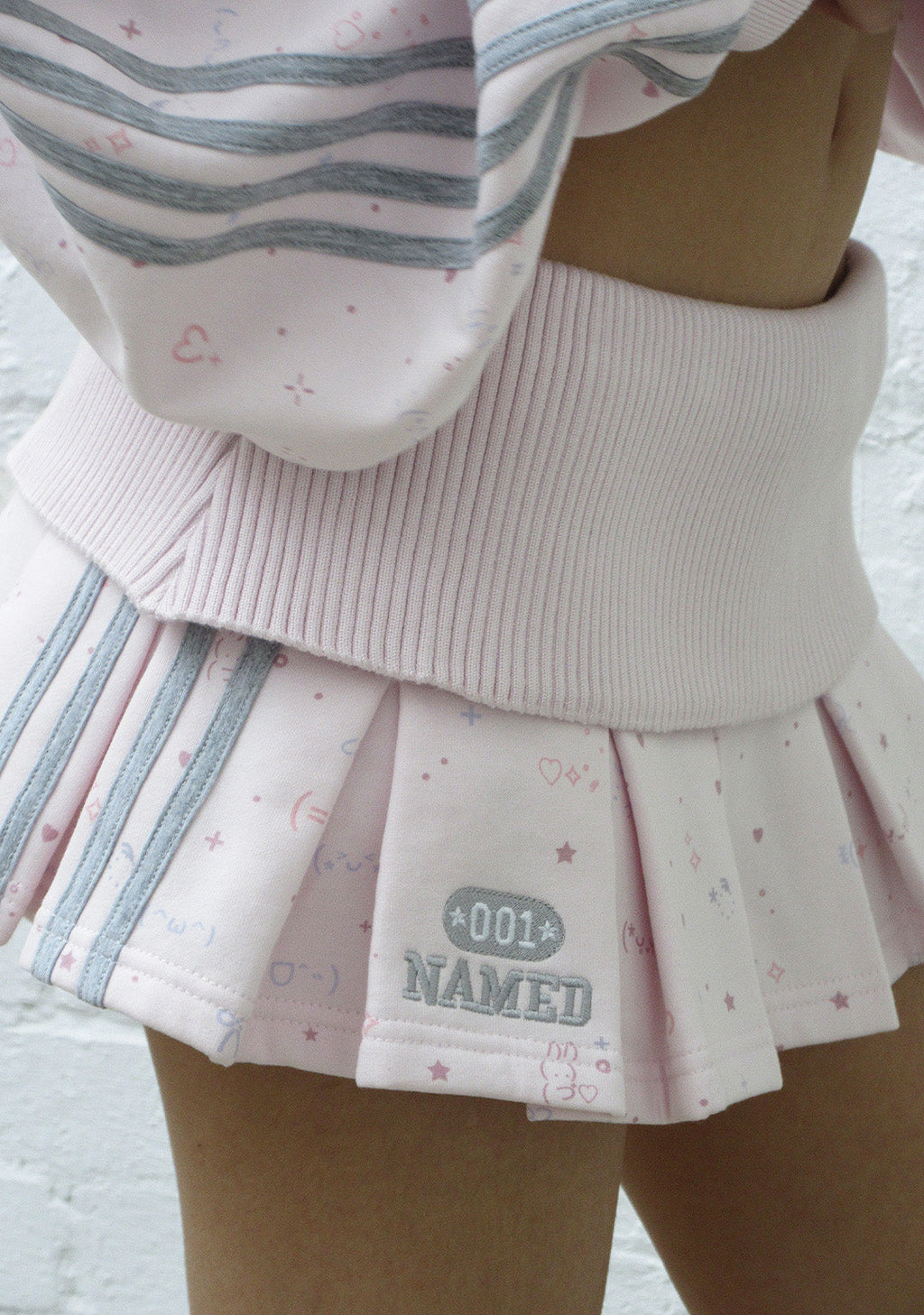 MALFUNCTION SPORTY PLEATED MINI SKIRT BABY PINK